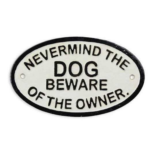 Oval cast iron wall plaque with the humorous message 'Nevermind the Dog Beware of the Owner' in black lettering on a white background.