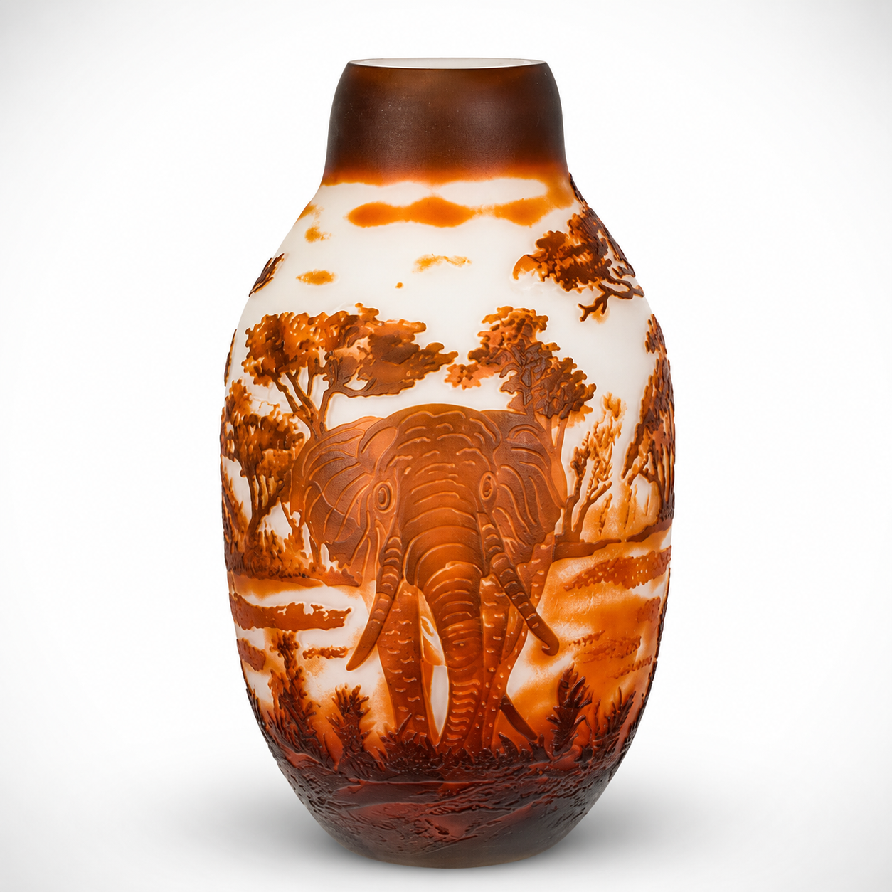 Handcrafted amber and white glass vase featuring an engraved elephant in a safari landscape with trees.