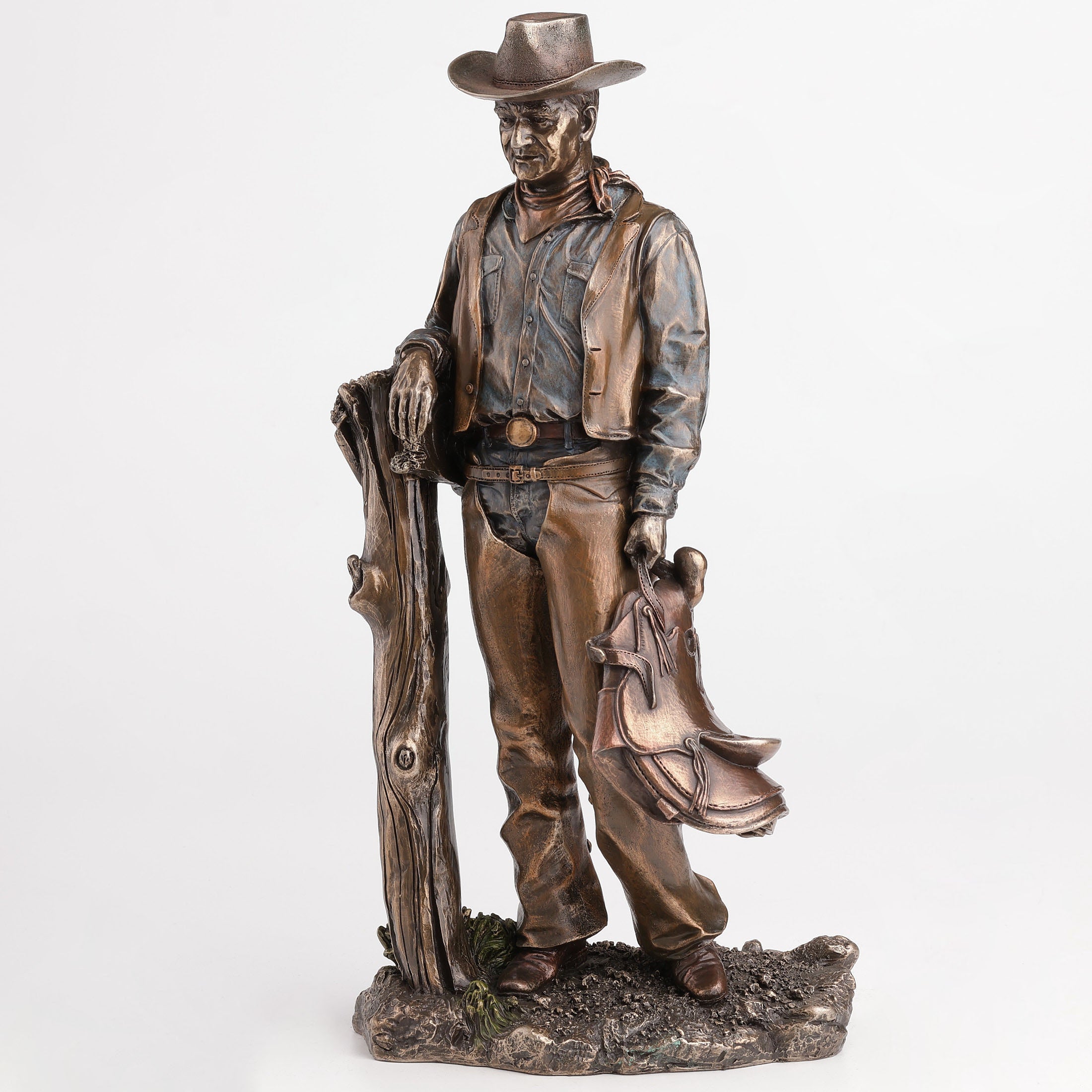 Cowboy Holding Saddle Leaning Against Fence Pole