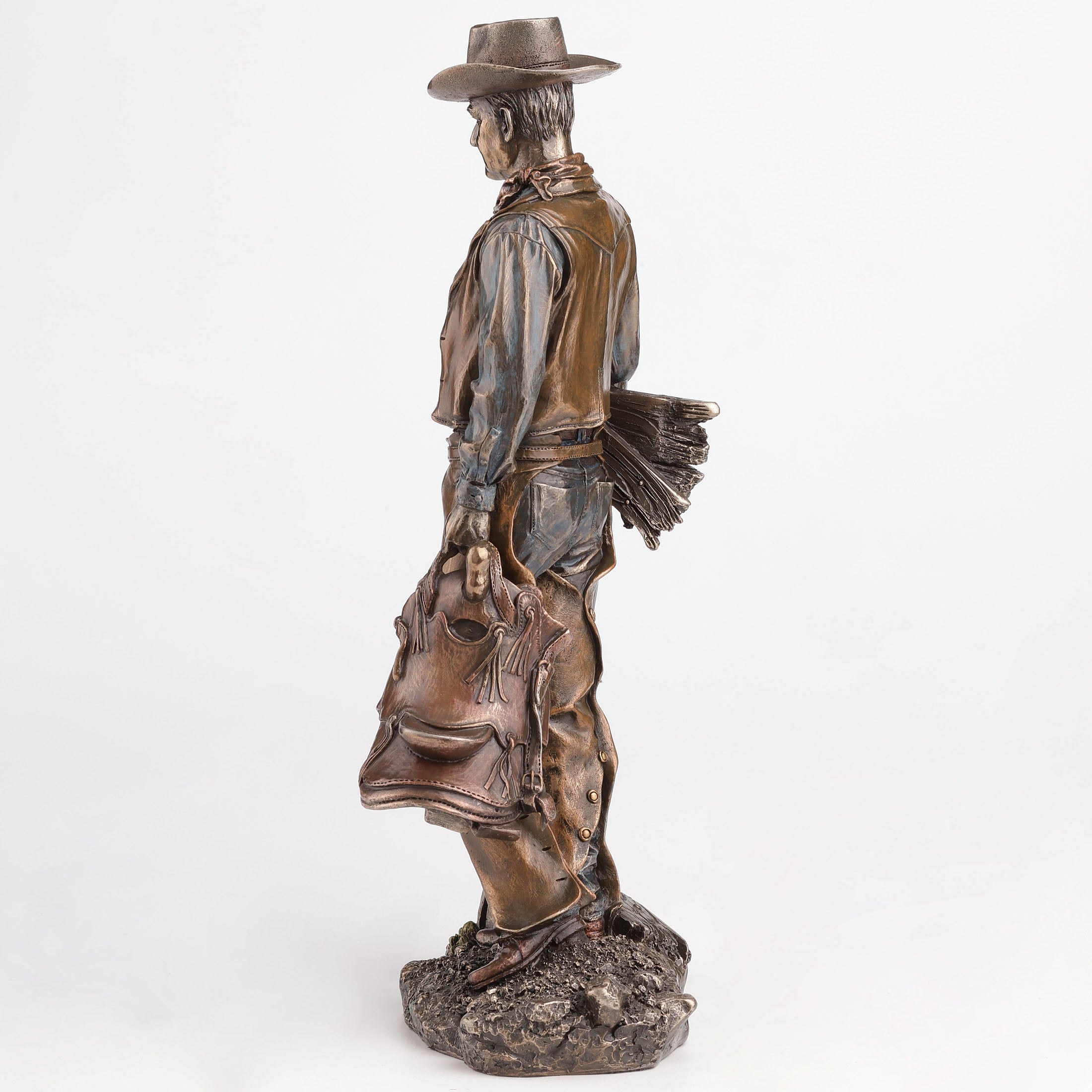 Cowboy Holding Saddle Leaning Against Fence Pole