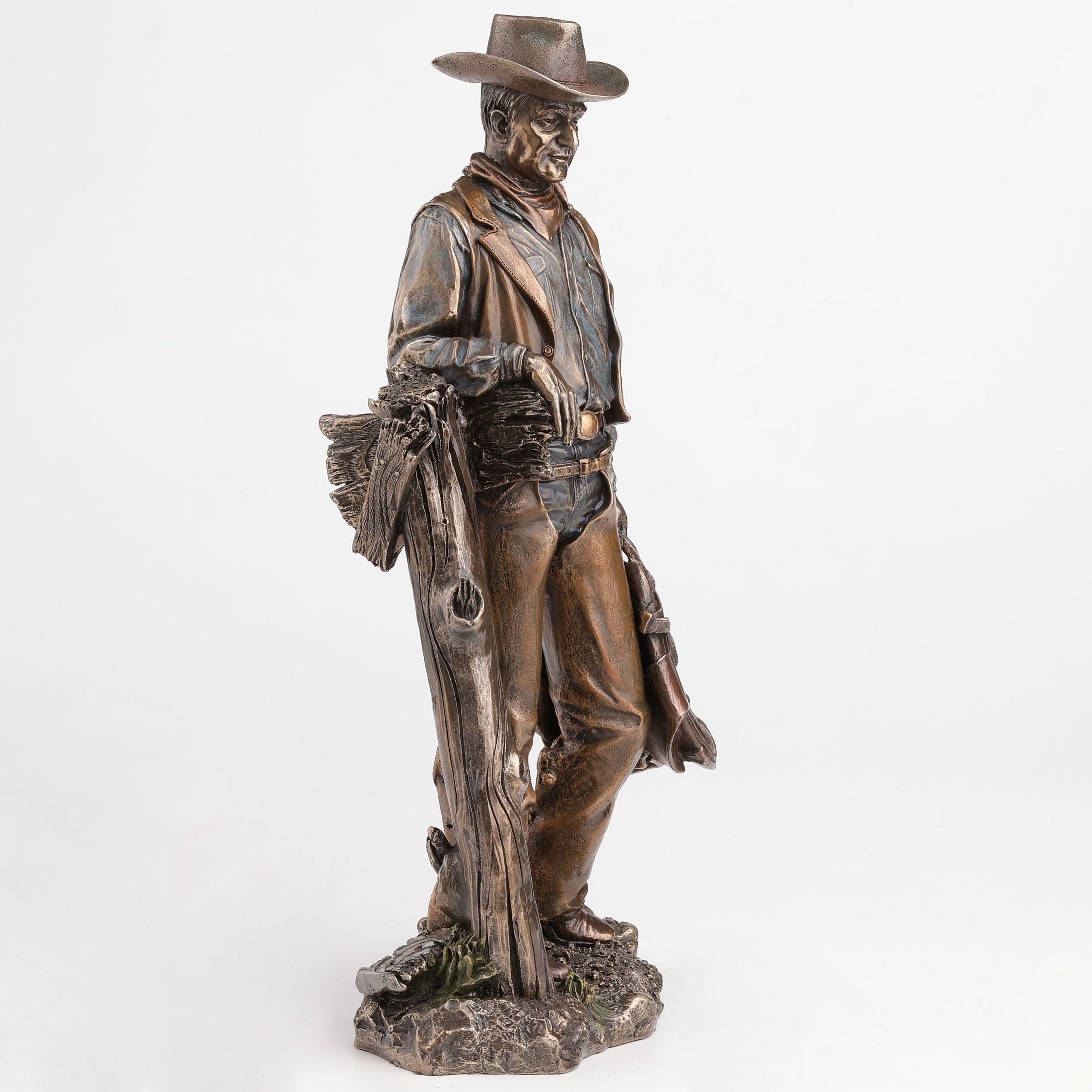 Cowboy Holding Saddle Leaning Against Fence Pole