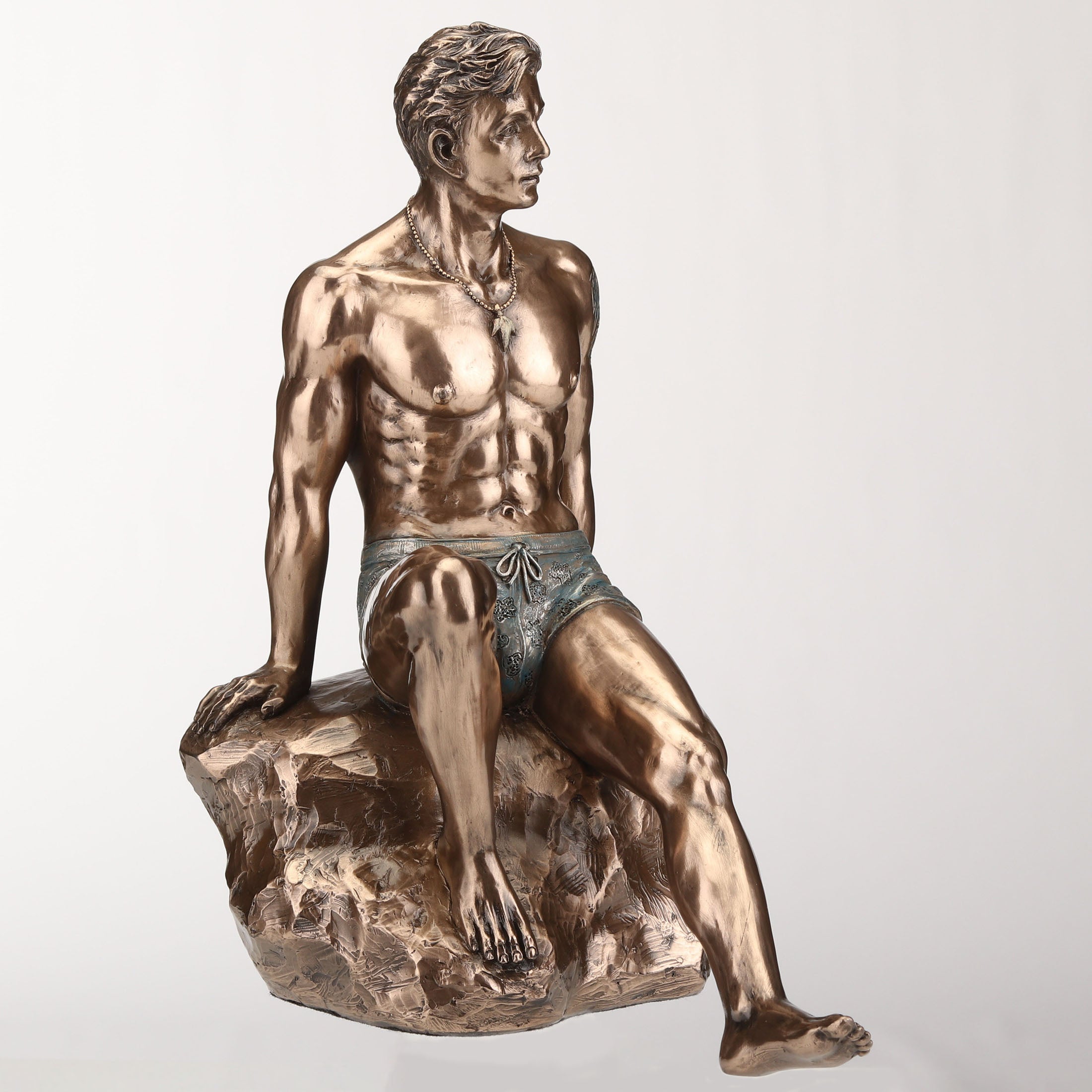 Tattooed Male Sitting On Rock Beach Pinup