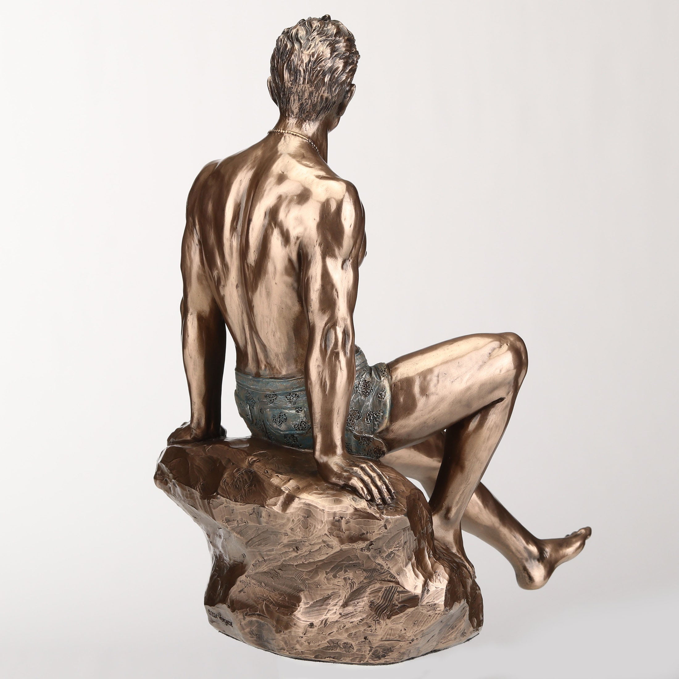 Tattooed Male Sitting On Rock Beach Pinup
