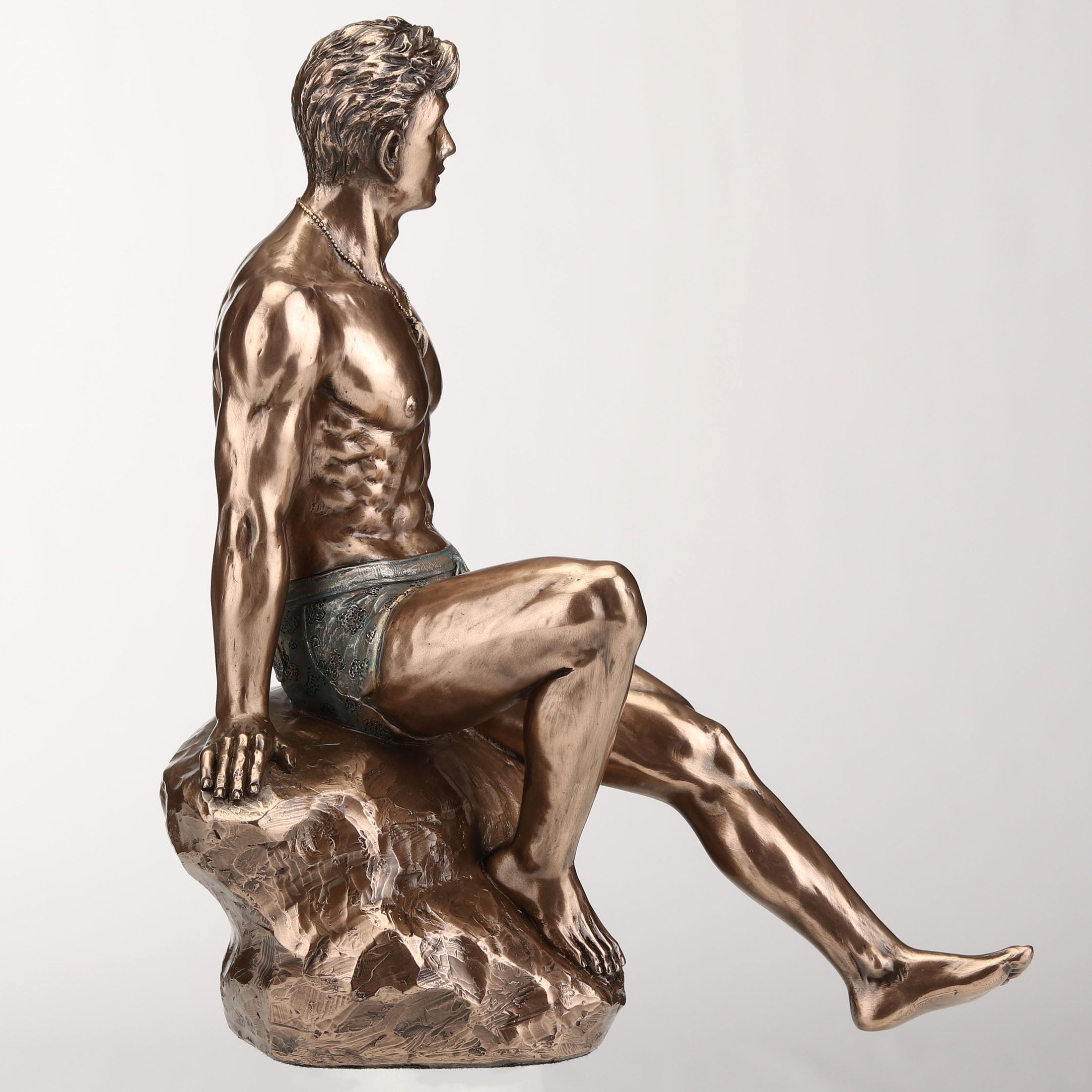 Tattooed Male Sitting On Rock Beach Pinup