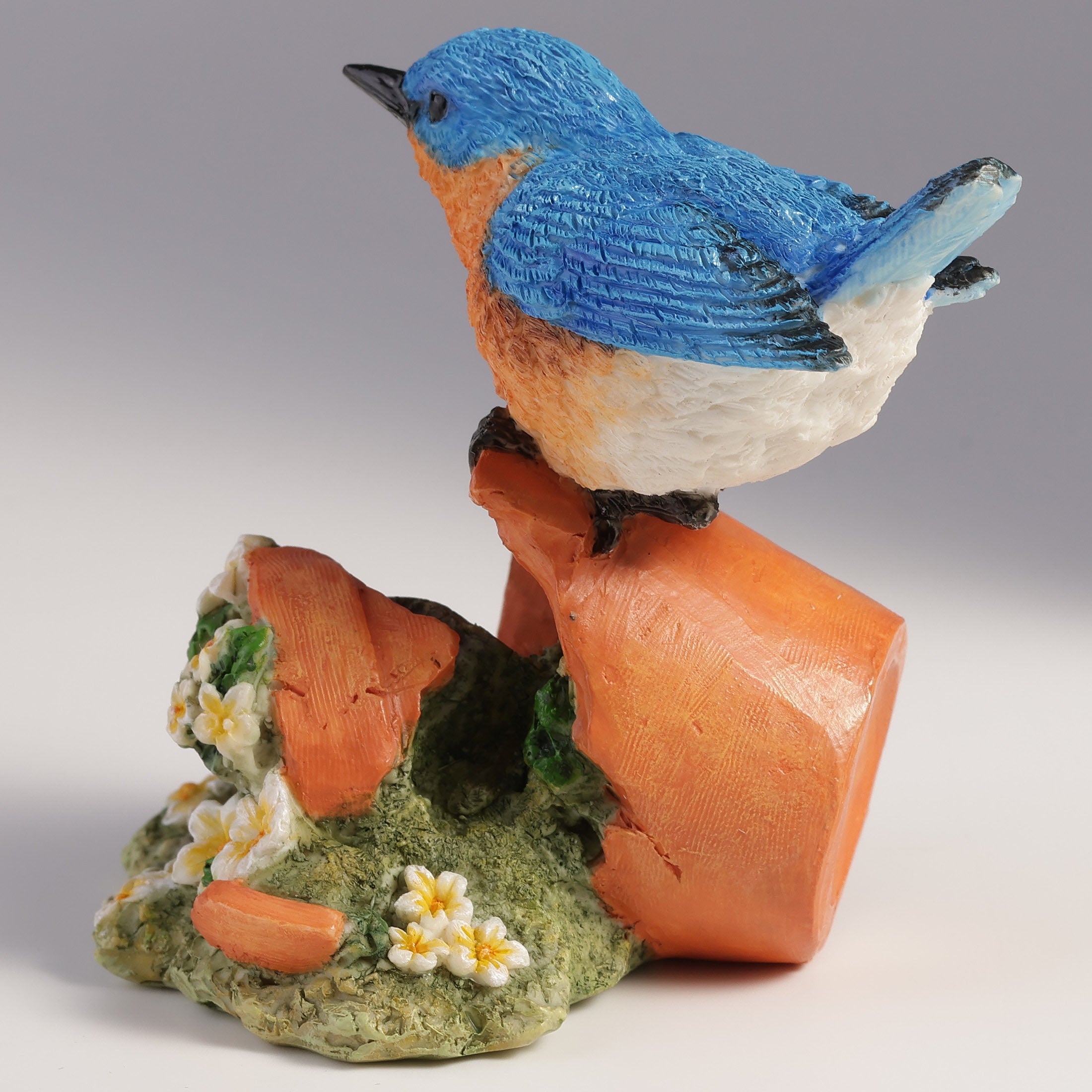 Bluebird Perching On Tipped Over Flower Pot